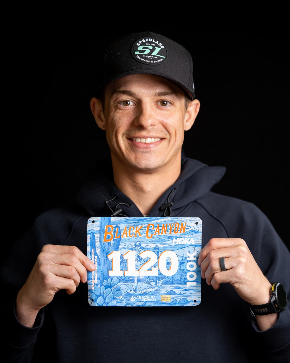 Eric Alexandres holding his Black Canyon 100K race bib